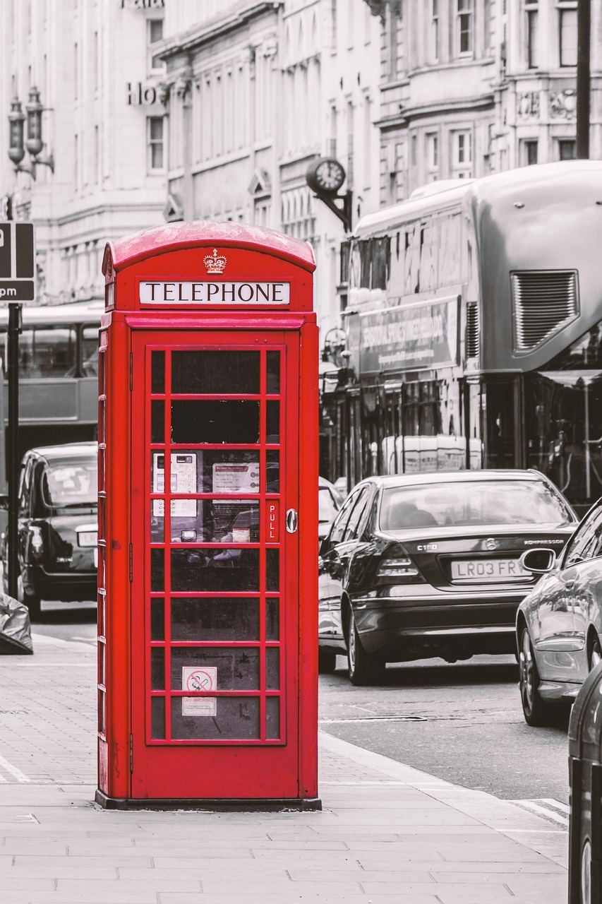 A traditional red telephone box on a London street